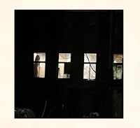 a picture of a building with windows in the dark